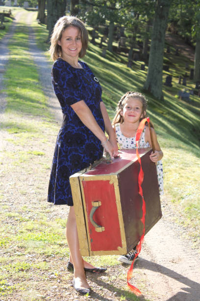 mother and daughter with a red suitcase are ready for an adventure